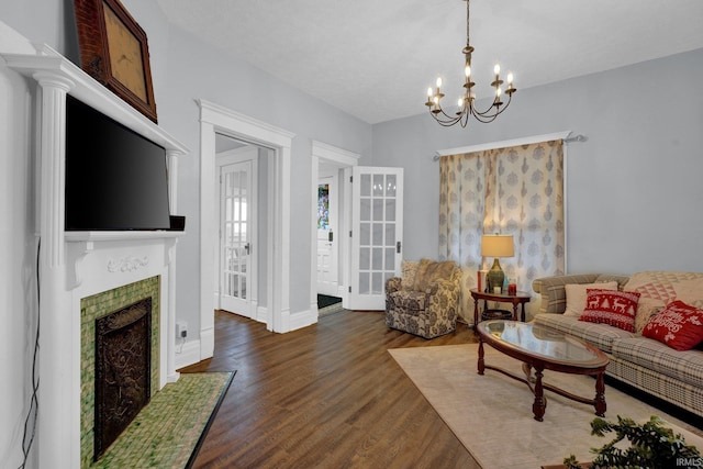 living room featuring dark hardwood / wood-style floors and an inviting chandelier