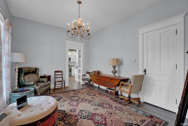 sitting room with dark hardwood / wood-style flooring and a notable chandelier