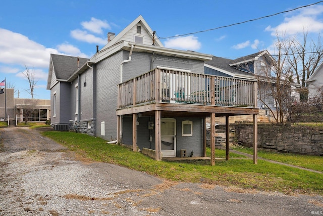 back of house with a wooden deck