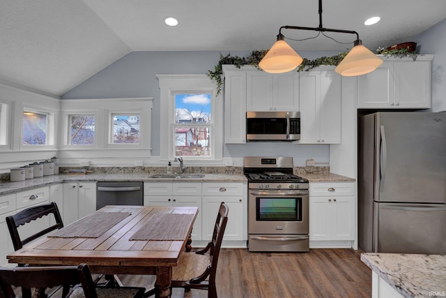 kitchen with pendant lighting, sink, white cabinetry, and stainless steel appliances