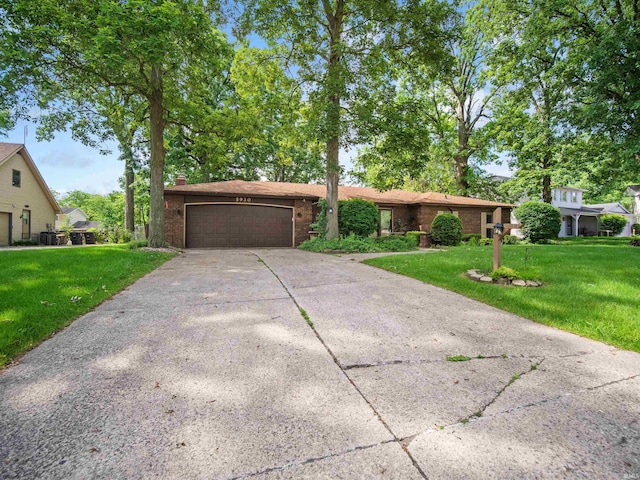 ranch-style house with a front yard and a garage