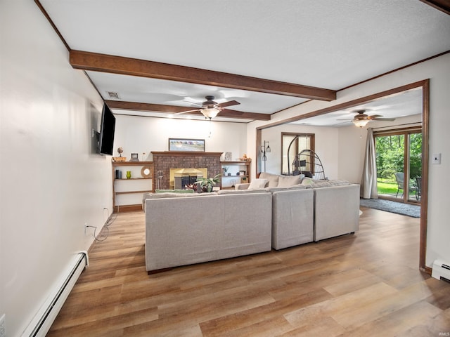 living room featuring beam ceiling, light hardwood / wood-style flooring, a brick fireplace, and a baseboard heating unit