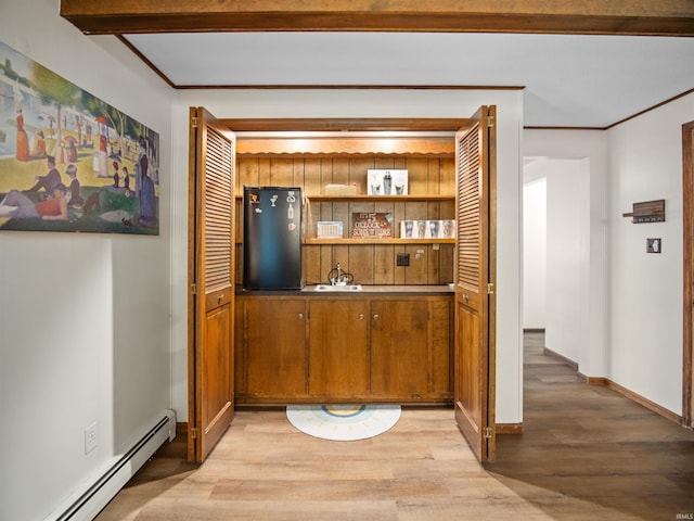 bar featuring baseboard heating, stainless steel refrigerator, crown molding, and light hardwood / wood-style floors