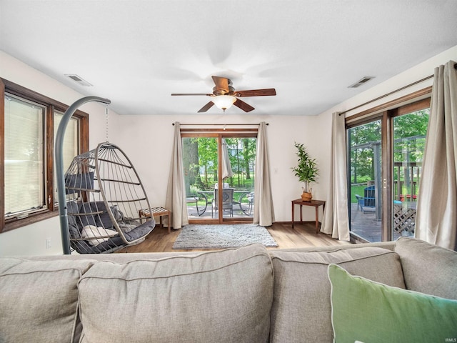 living room with hardwood / wood-style floors and ceiling fan