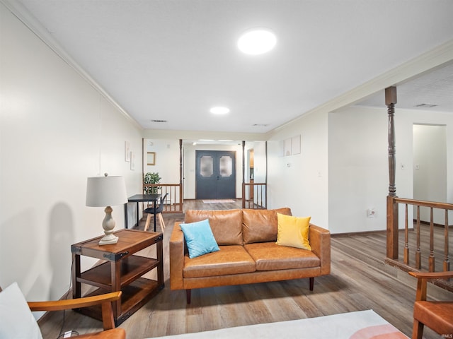 living room featuring hardwood / wood-style flooring and ornamental molding