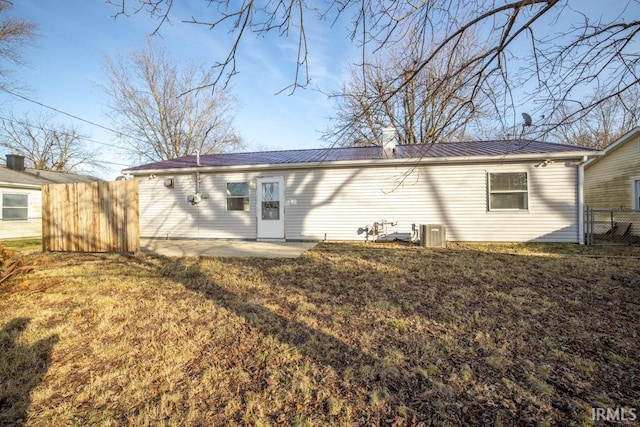 rear view of property with a lawn and a patio area