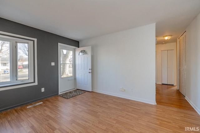 foyer entrance with light wood-type flooring