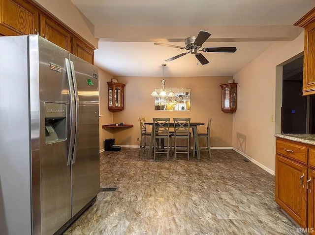 kitchen with light stone countertops, ceiling fan, beam ceiling, decorative light fixtures, and stainless steel fridge with ice dispenser