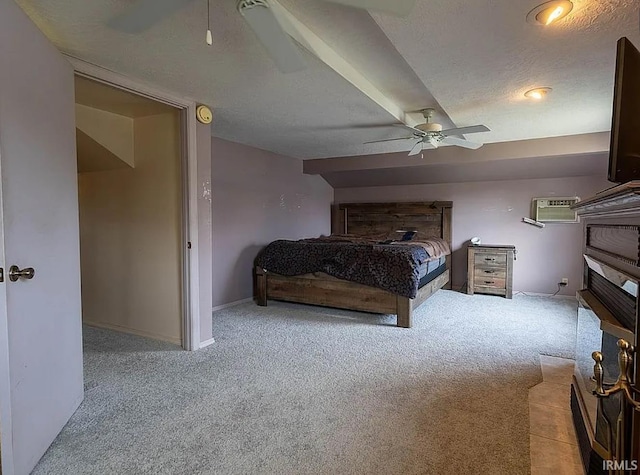 carpeted bedroom featuring a wall mounted air conditioner, a textured ceiling, and ceiling fan