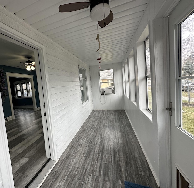 unfurnished sunroom with ceiling fan and cooling unit