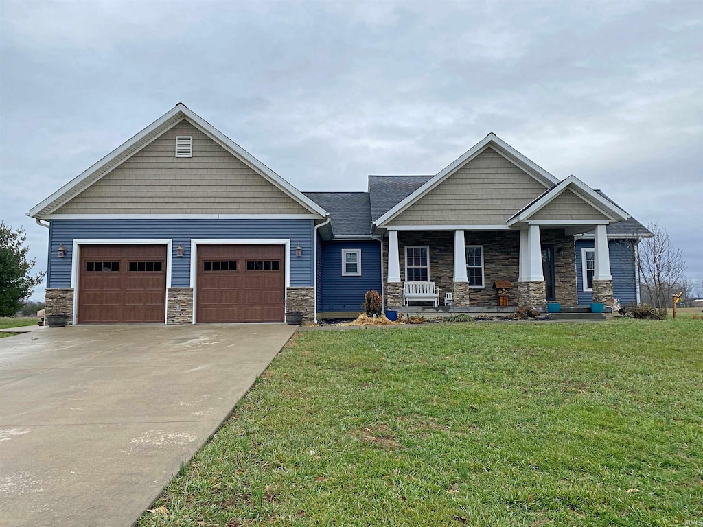 craftsman inspired home featuring a front yard, a porch, and a garage