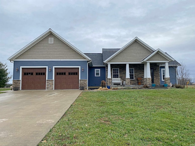 craftsman inspired home featuring a front yard, a porch, and a garage