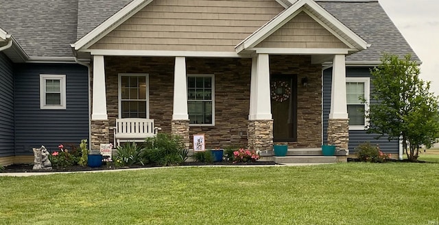 property entrance featuring a lawn and a porch