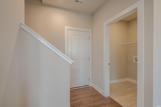 hallway with hardwood / wood-style floors