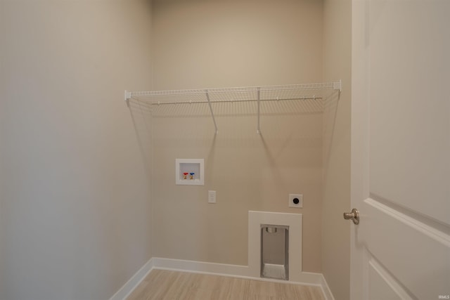 laundry area with hookup for an electric dryer, light wood-type flooring, and hookup for a washing machine