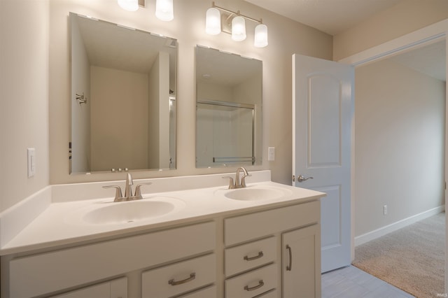 bathroom featuring vanity and a shower with shower door