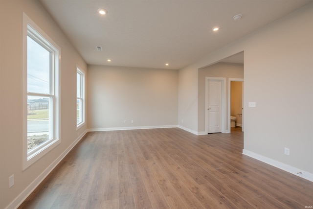 empty room with light hardwood / wood-style flooring