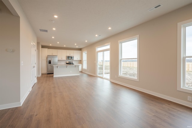 unfurnished living room with light hardwood / wood-style flooring