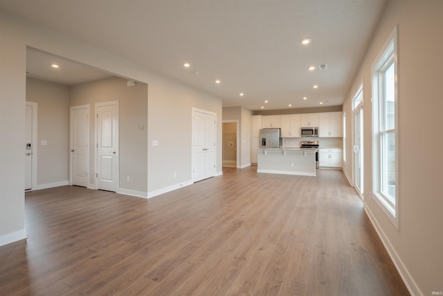 unfurnished living room with light hardwood / wood-style flooring