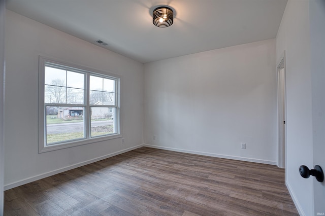 unfurnished room with dark hardwood / wood-style floors