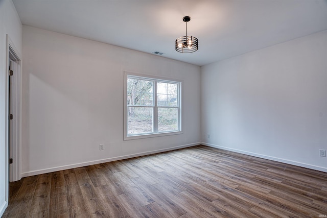 spare room with hardwood / wood-style floors