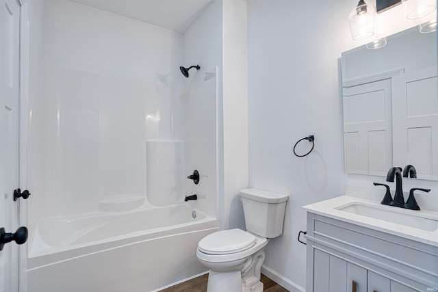 full bathroom with hardwood / wood-style flooring, toilet, vanity, and tub / shower combination