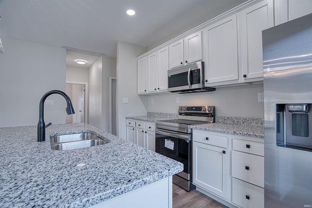 kitchen featuring sink, white cabinets, and stainless steel appliances