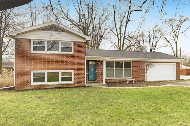 tri-level home featuring a garage and a front lawn