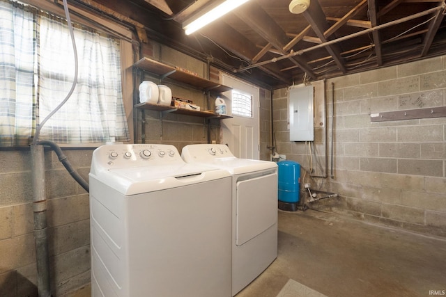 clothes washing area featuring separate washer and dryer and electric panel