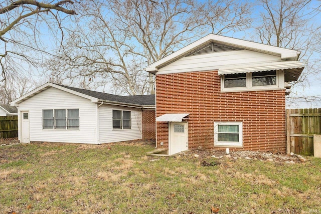 back of house featuring a lawn