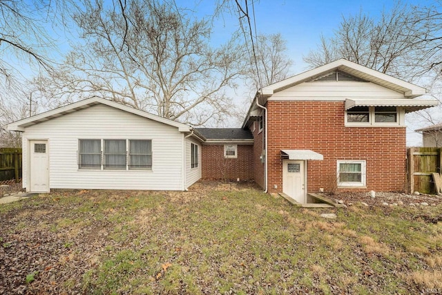 rear view of house with a lawn