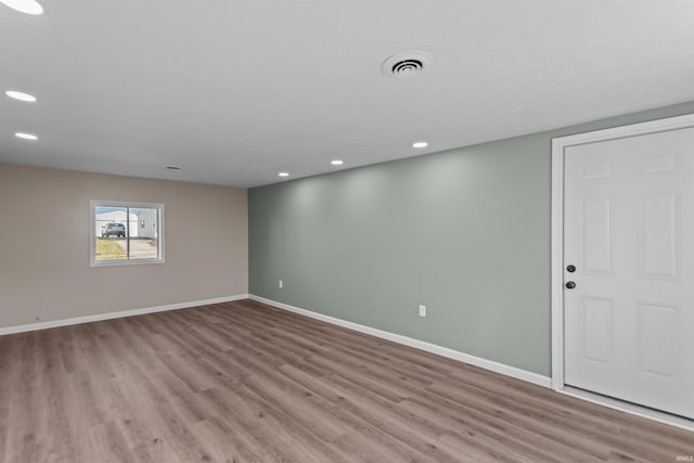 unfurnished room with light wood-type flooring