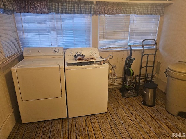 washroom with washing machine and clothes dryer and dark wood-type flooring