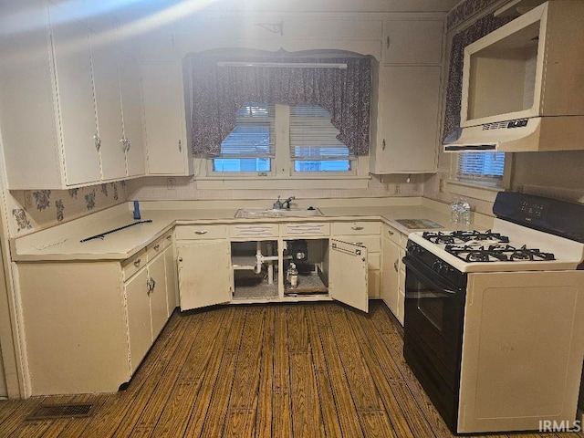 kitchen with white cabinets, dark hardwood / wood-style floors, gas range gas stove, and sink