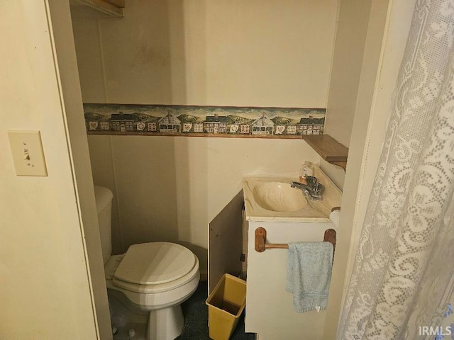 bathroom featuring vanity, toilet, and tile walls