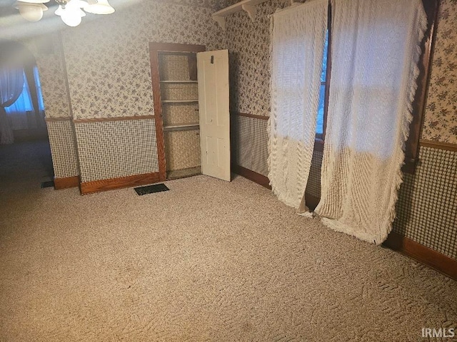 unfurnished bedroom with ceiling fan and carpet