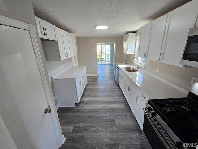 kitchen featuring a textured ceiling, white cabinetry, sink, and appliances with stainless steel finishes