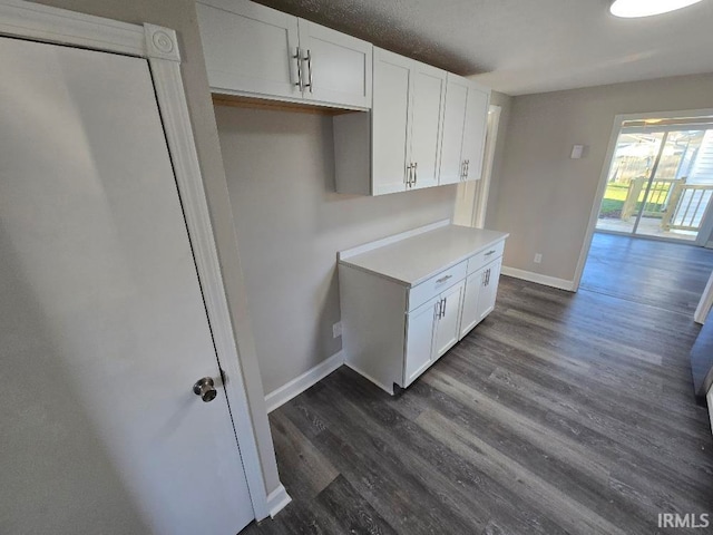 kitchen featuring white cabinets and dark hardwood / wood-style flooring