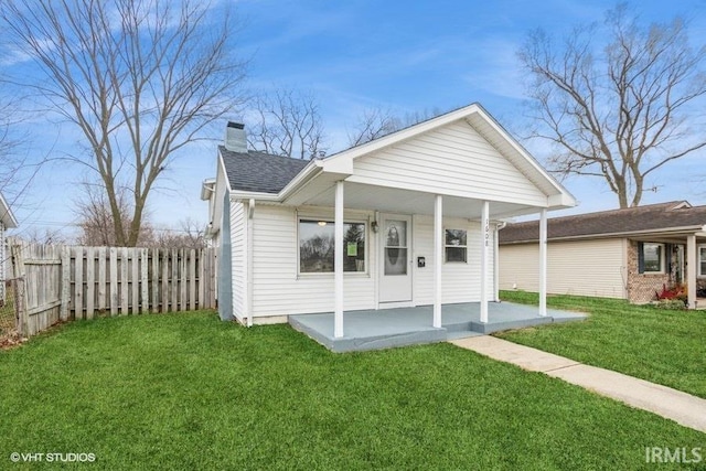 view of front of property with covered porch and a front yard