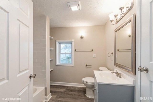 bathroom featuring a textured ceiling, vanity, toilet, and wood-type flooring