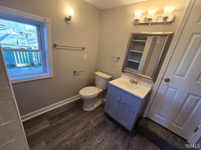 bathroom featuring vanity, hardwood / wood-style flooring, and toilet