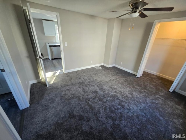 unfurnished bedroom featuring ceiling fan and dark carpet