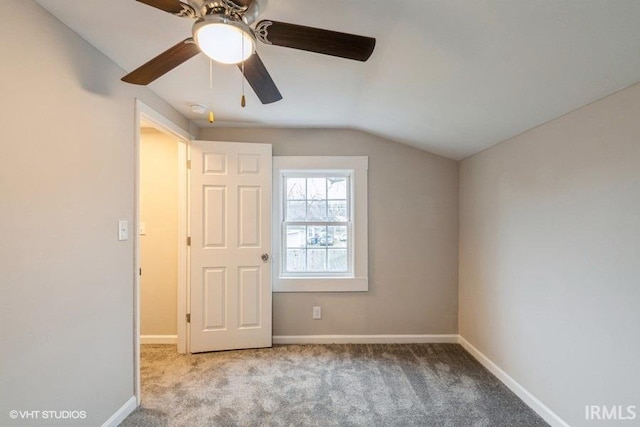 unfurnished bedroom with ceiling fan, carpet, and vaulted ceiling