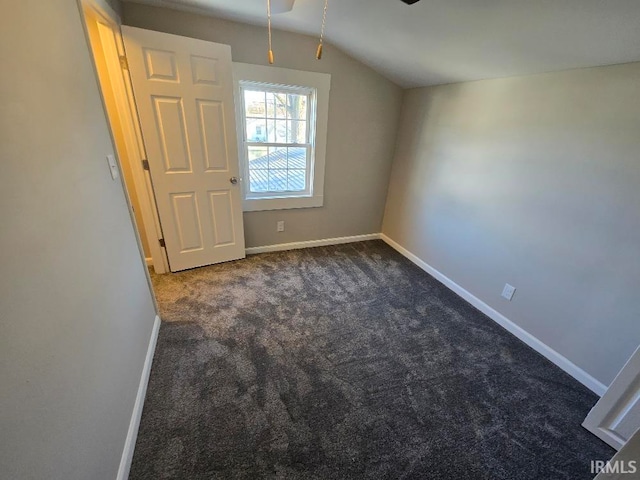 additional living space featuring ceiling fan, dark carpet, and lofted ceiling