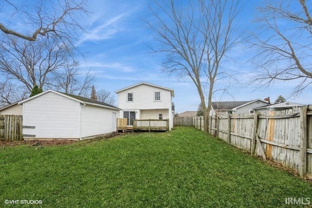 back of house featuring a lawn and a wooden deck