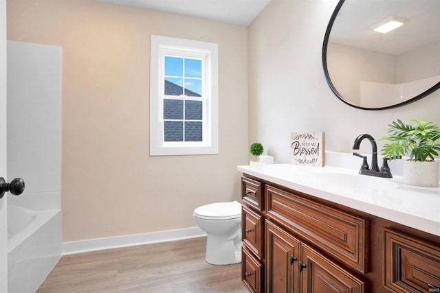 full bathroom featuring hardwood / wood-style flooring, vanity, toilet, and shower / bath combination