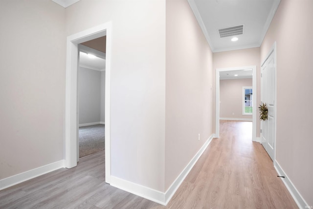 hall featuring light hardwood / wood-style flooring and ornamental molding