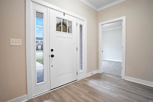 foyer entrance featuring light wood-type flooring and crown molding