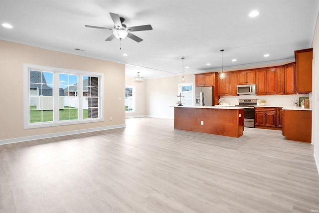 kitchen with ceiling fan with notable chandelier, stainless steel appliances, pendant lighting, light hardwood / wood-style floors, and a kitchen island