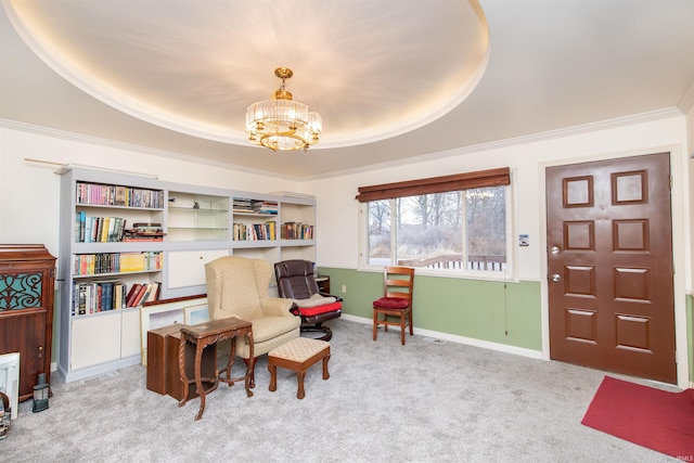 living area with a raised ceiling, crown molding, light carpet, and an inviting chandelier